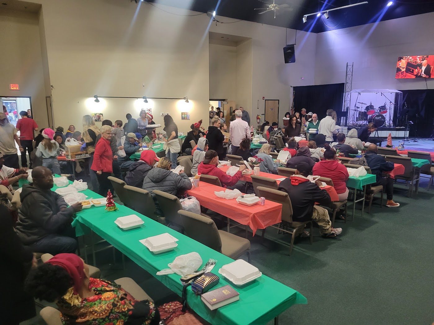 A full hall of neighbors at a Christmas dinner