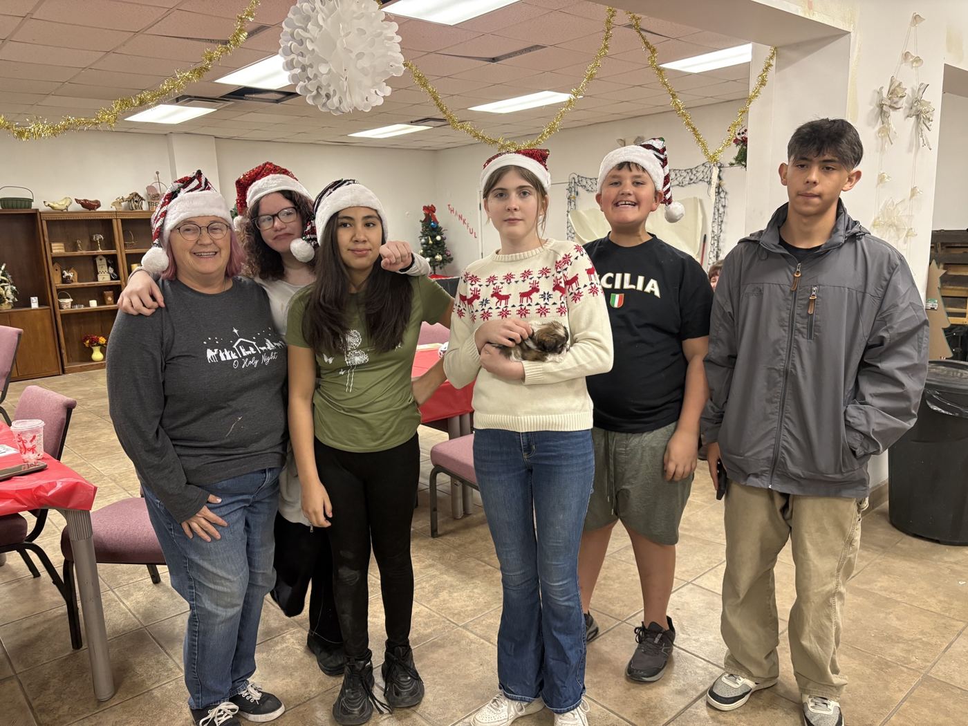 Volunteers in Santa hats at a Christmas event
