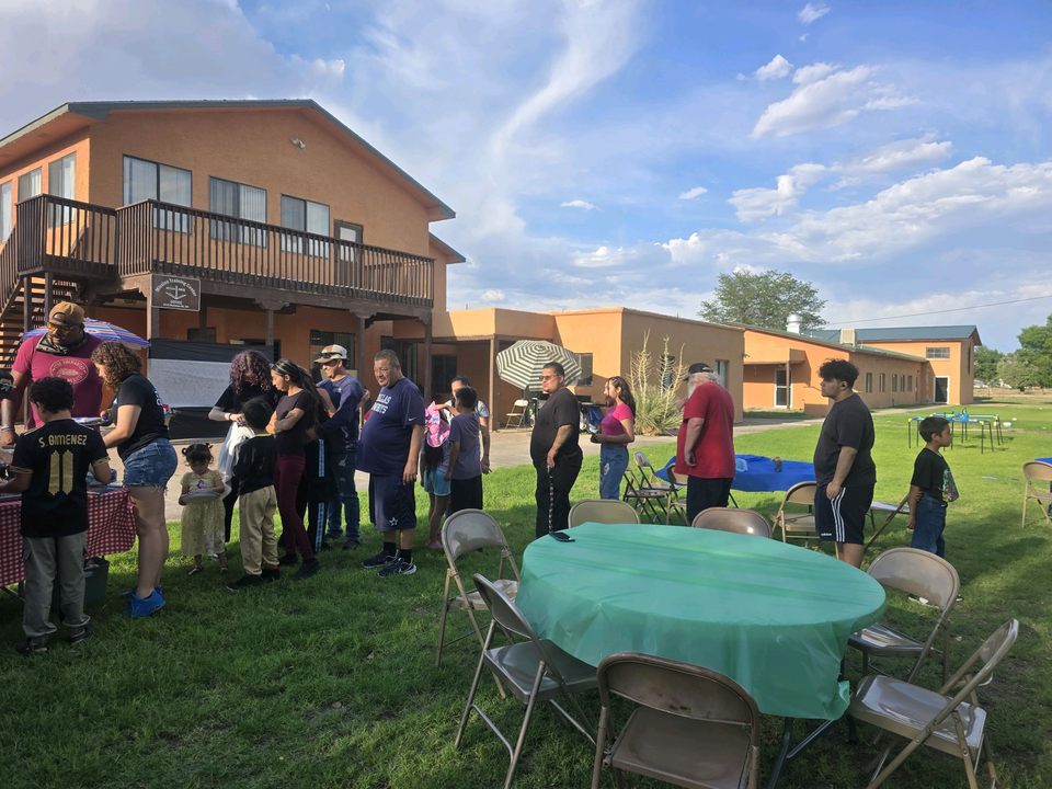 Families at tables on the lawn outside the South Valley church