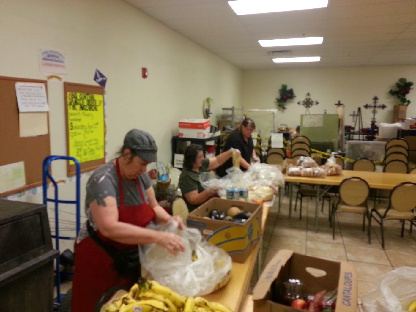 A volunteer bagging bananas in the food bank