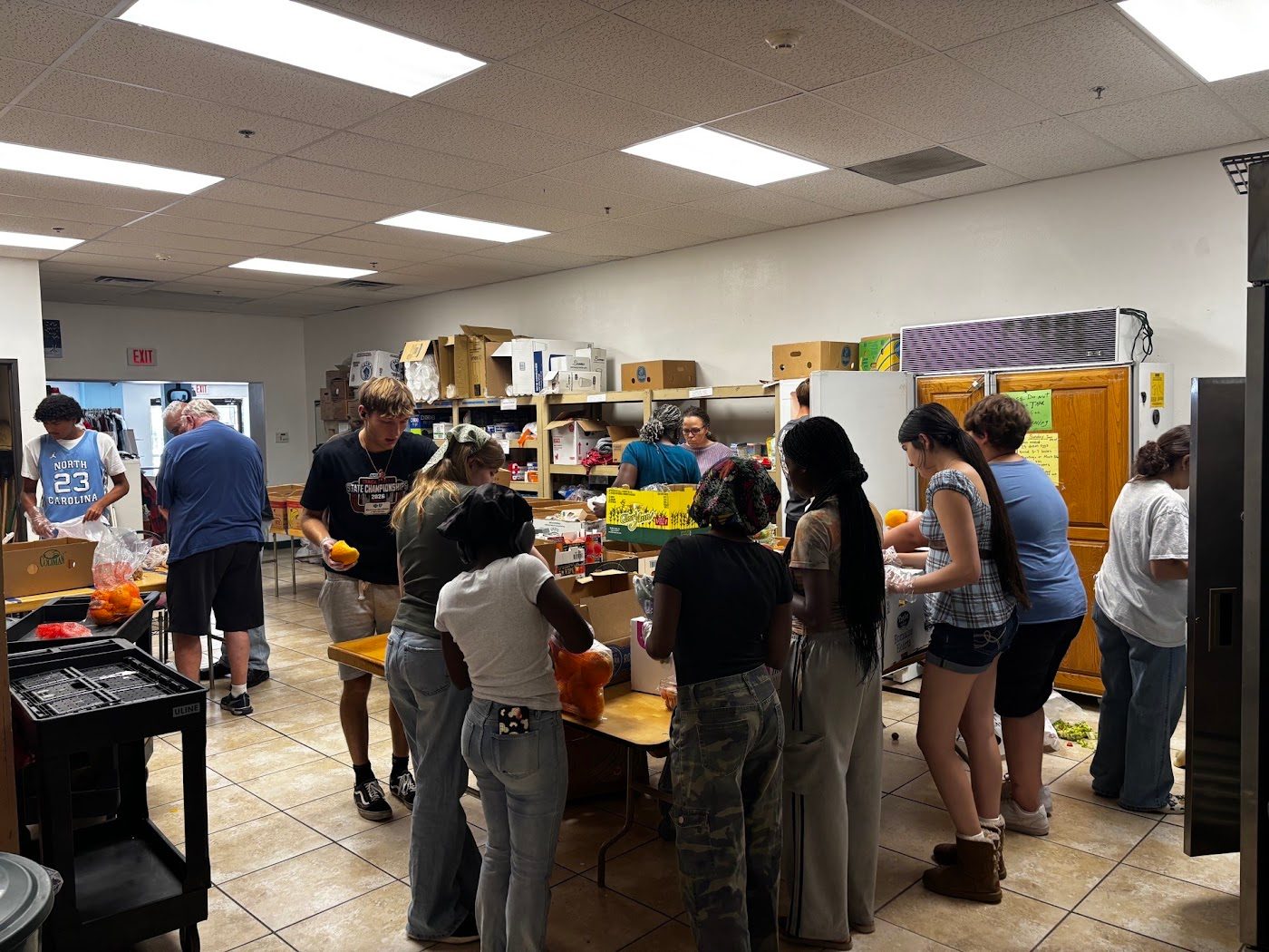A crowded food bank room full of volunteers