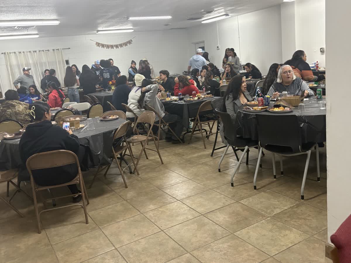 About ninety neighbors at a harvest dinner