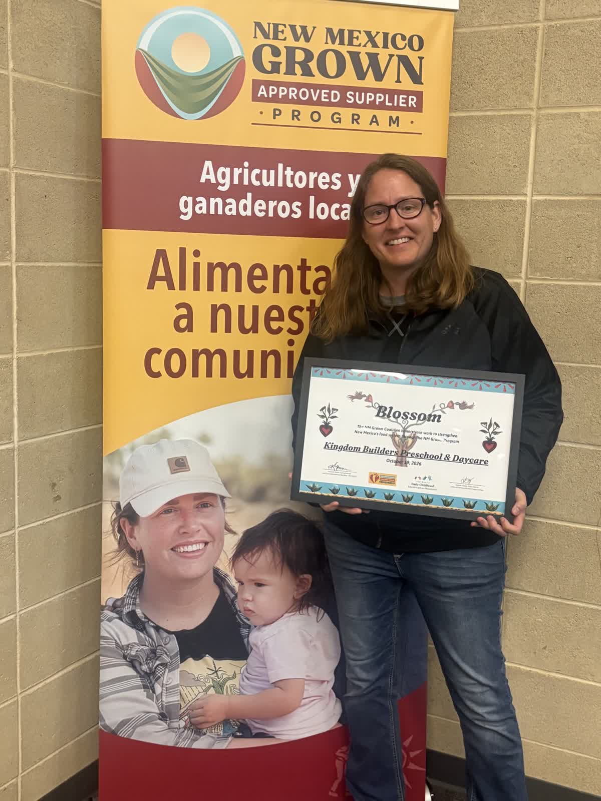 Kingdom Builders staff holding the NM Grown BLOSSOM Award