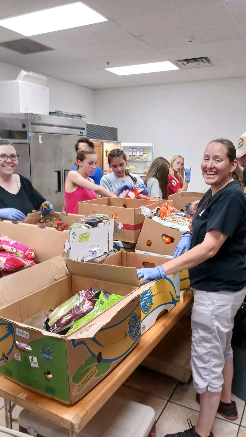 Volunteers packing boxes of groceries