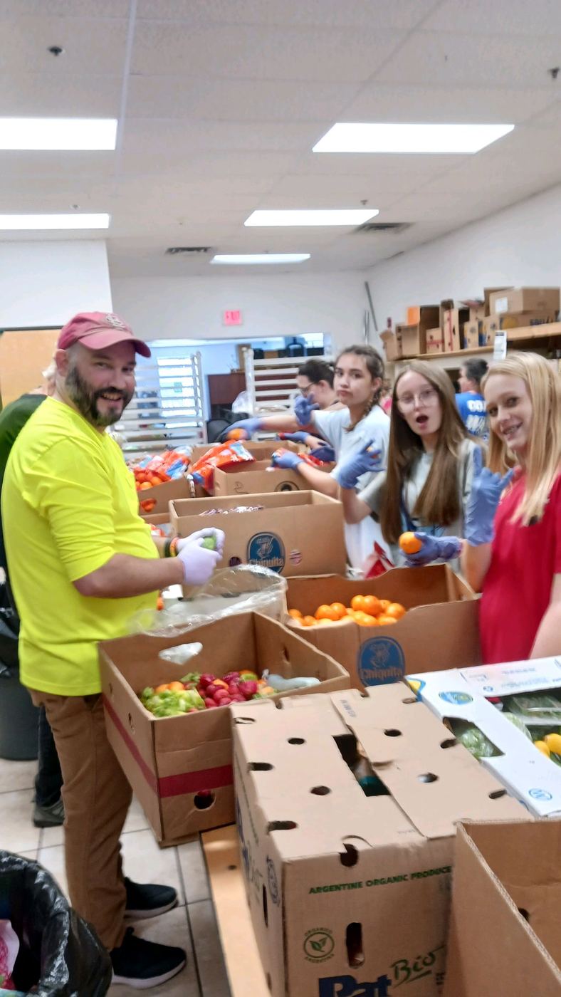 Volunteers filling boxes with fresh produce