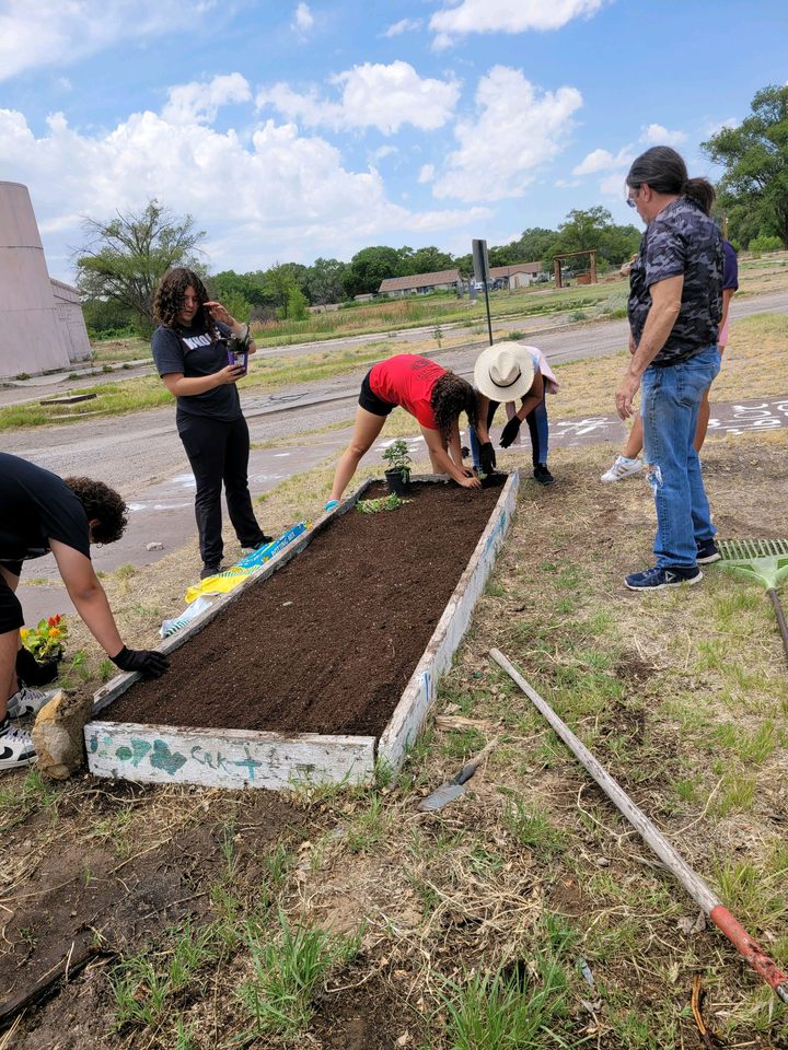 Teens building raised garden beds on the South Valley campus