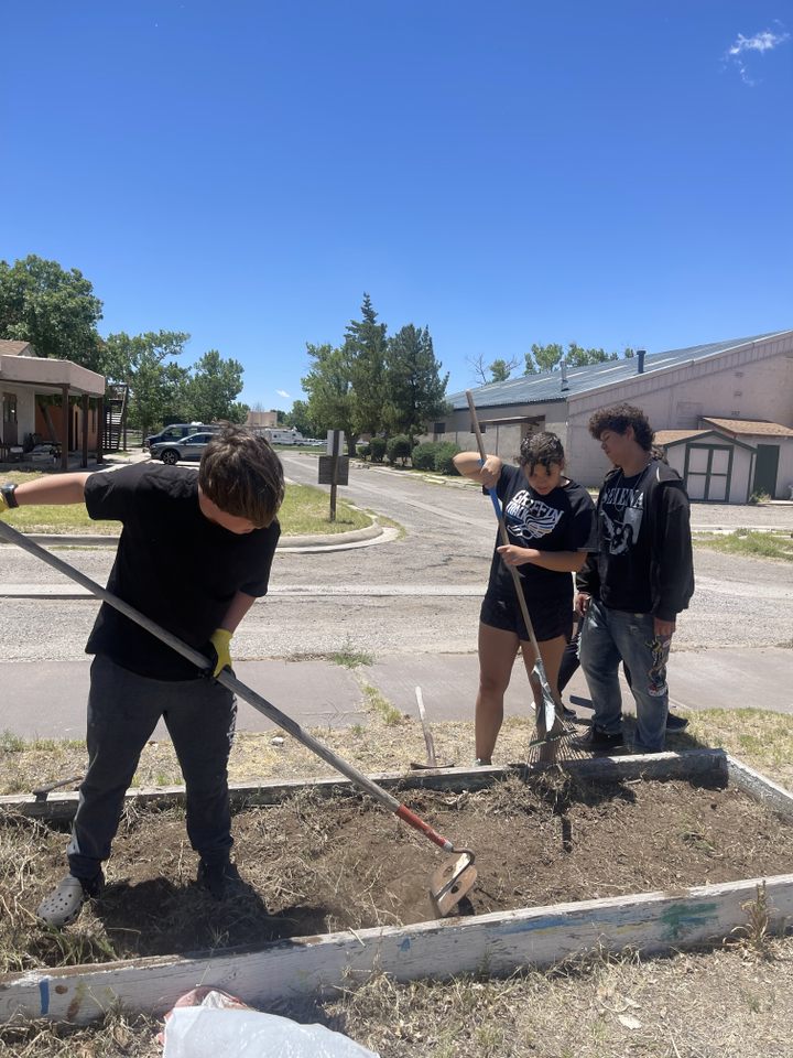 Teens digging a new garden on the South Valley campus