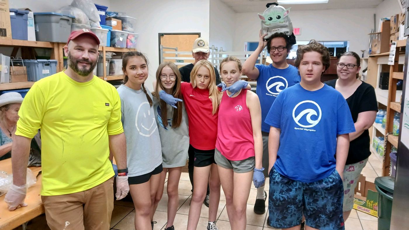 A youth mission team in a supply room